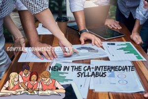 Group of people analyzing charts and graphs on a table, symbolizing the new updates in the CA-Intermediate syllabus taught at Gowtham Commerce Institute in Peelamedu, Coimbatore